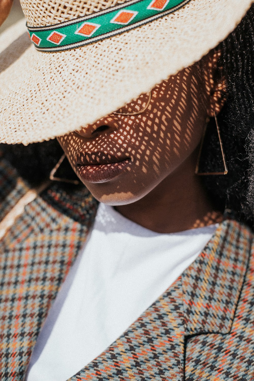 woman in white and red collared shirt wearing white hat