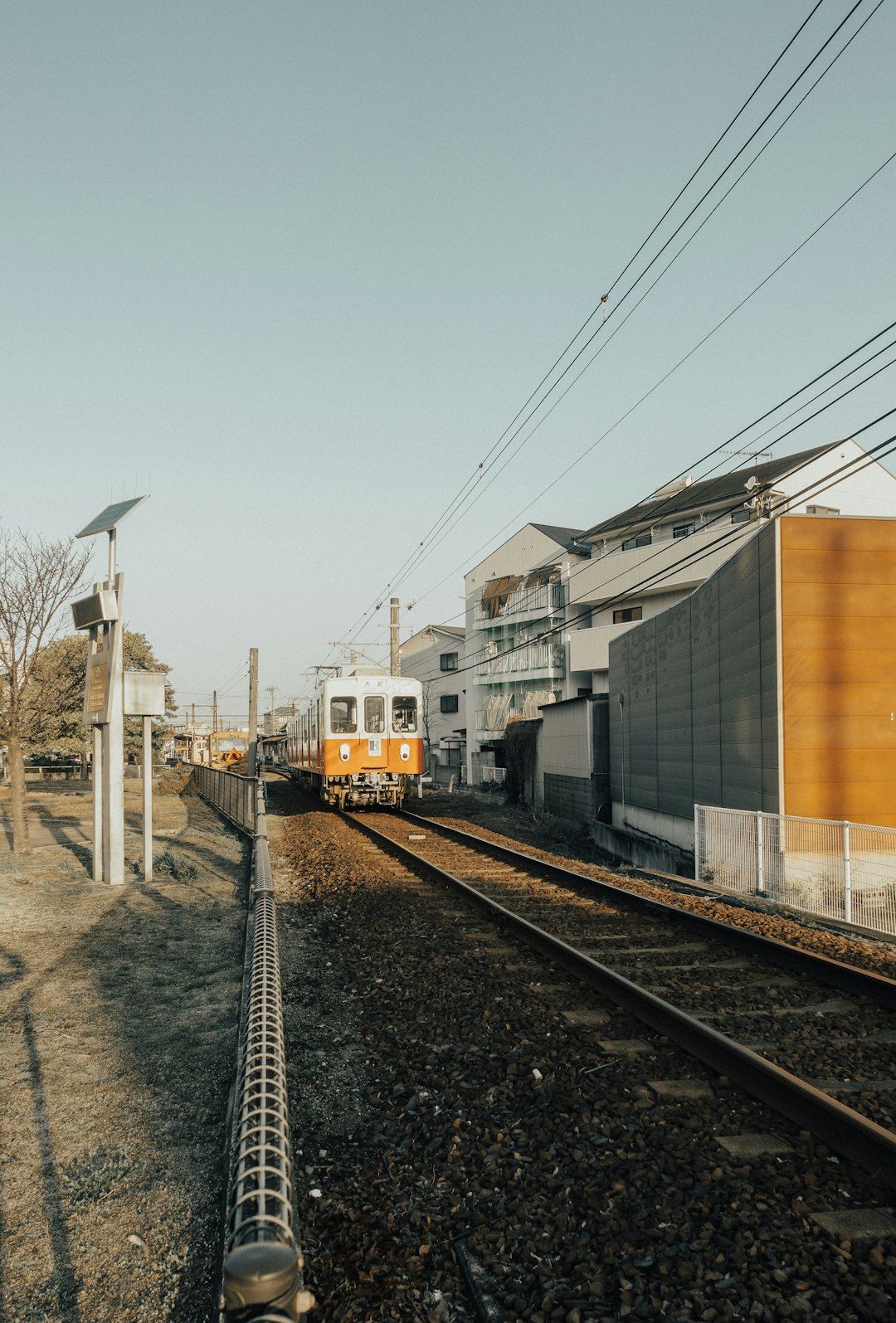 yellow and black train on rail tracks during daytime