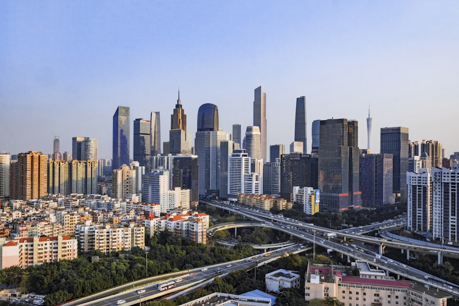 Guangzhou city skyline with modern skyscrapers and Pearl River under blue sky