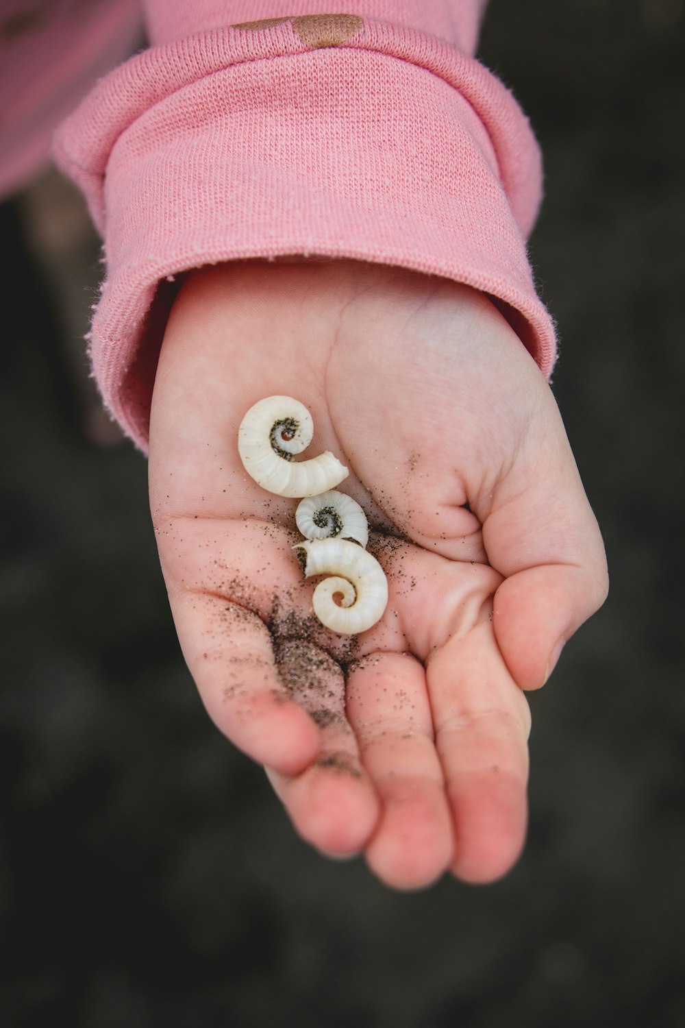 person with white pearl on hand