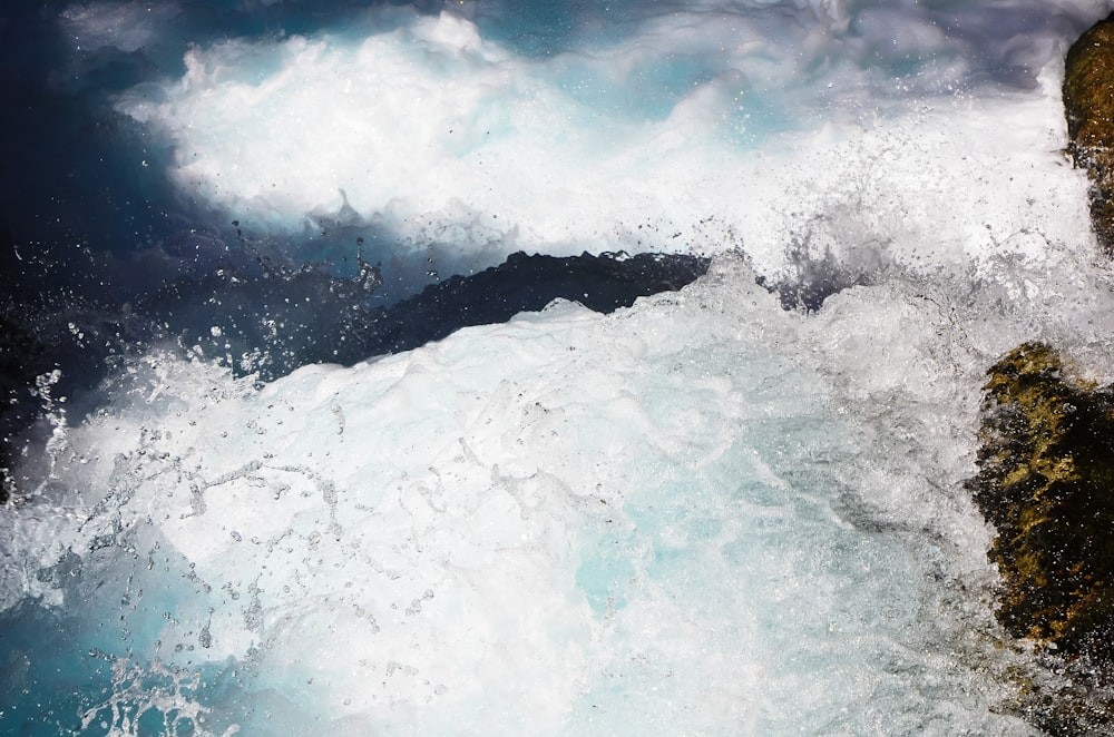 ocean waves crashing on shore during daytime