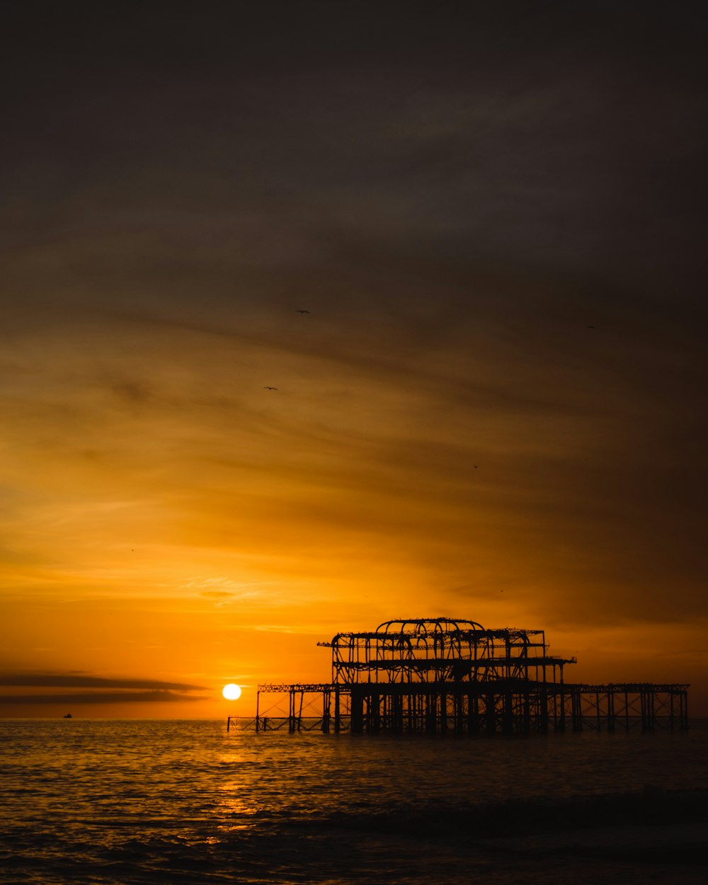 silhouette of dock during sunset