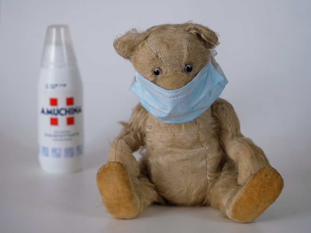 brown bear plush toy on white table