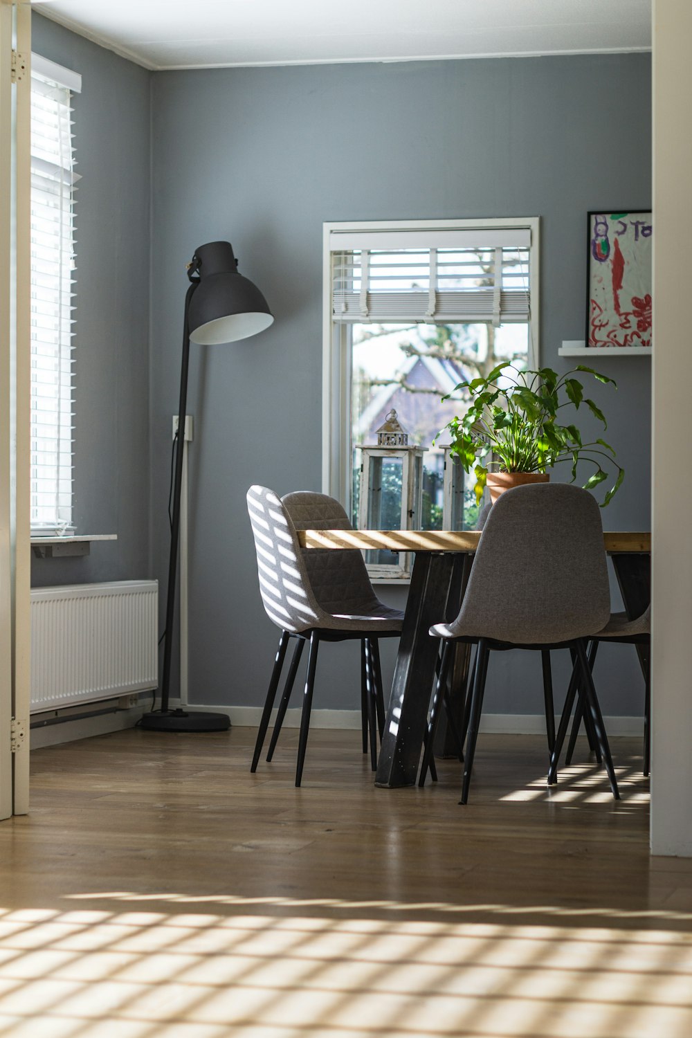 black and white floor lamp beside white window blinds