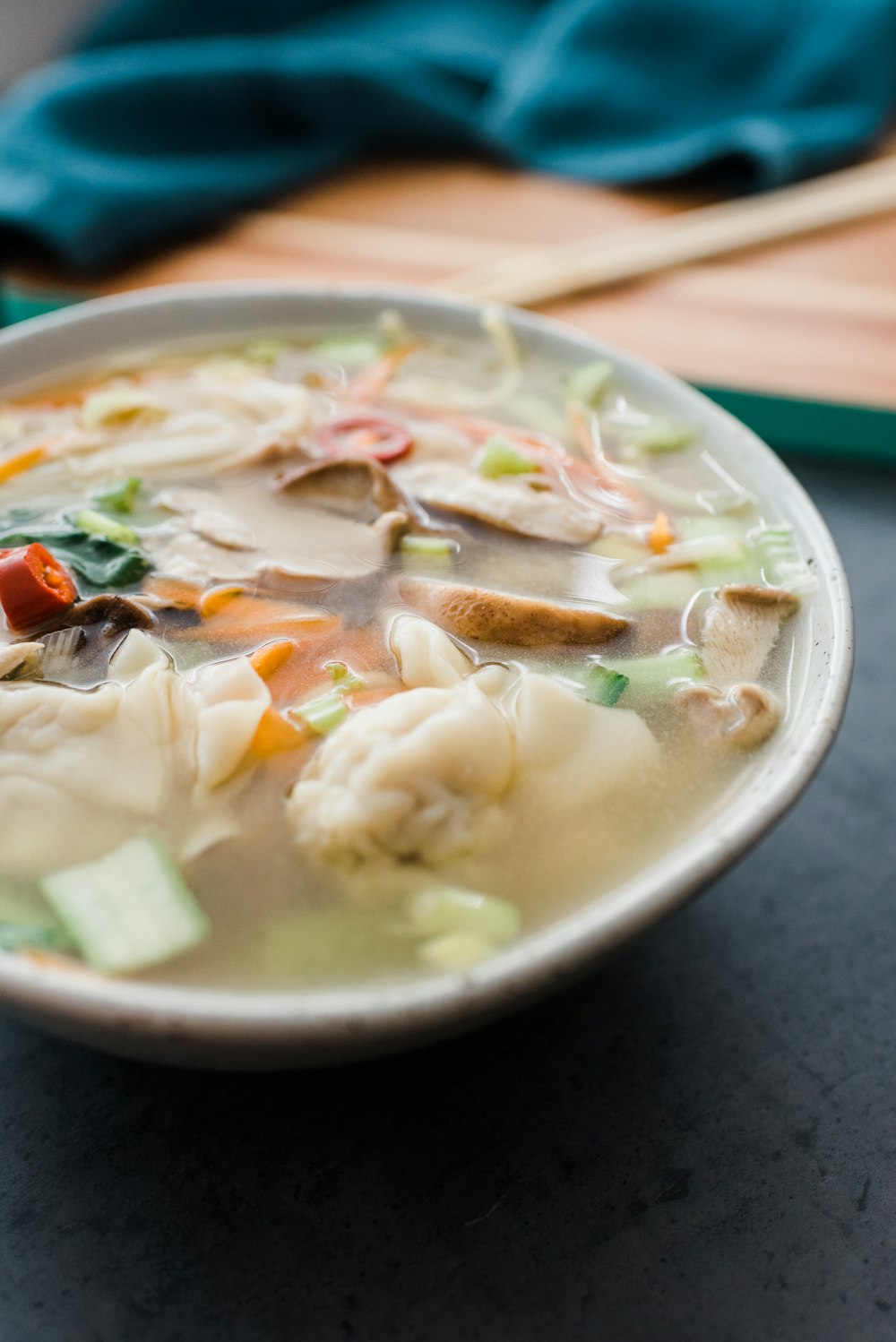 soup with meat and vegetables in white ceramic bowl