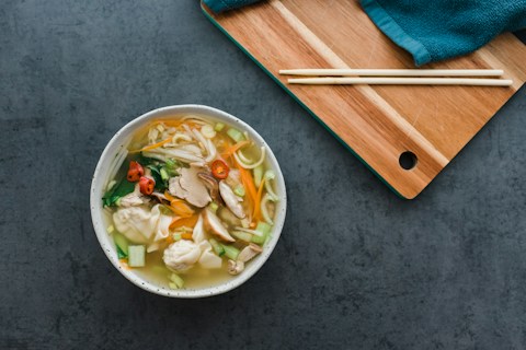 white ceramic bowl with brown wooden chopsticks