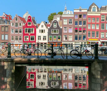 bicycles leaning on black metal fence in Amsterdam
