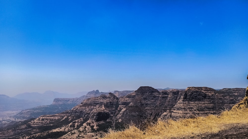 brown rocky mountain under blue sky during daytime