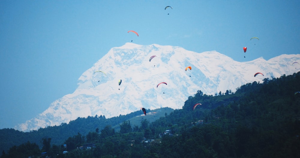 people on a beach with a view of a mountain under blue sky during daytime