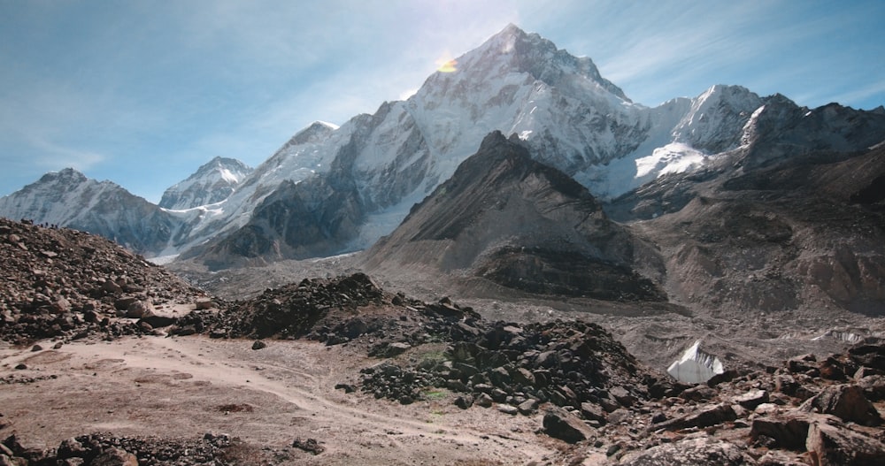 montagne brune et grise sous des nuages blancs pendant la journée