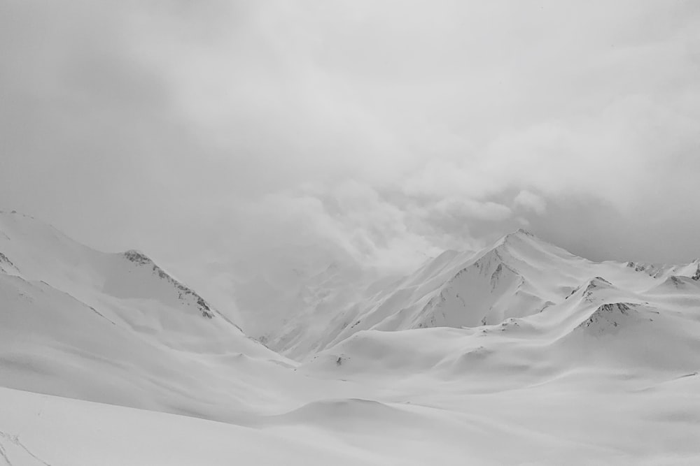 grayscale photo of mountains covered by snow