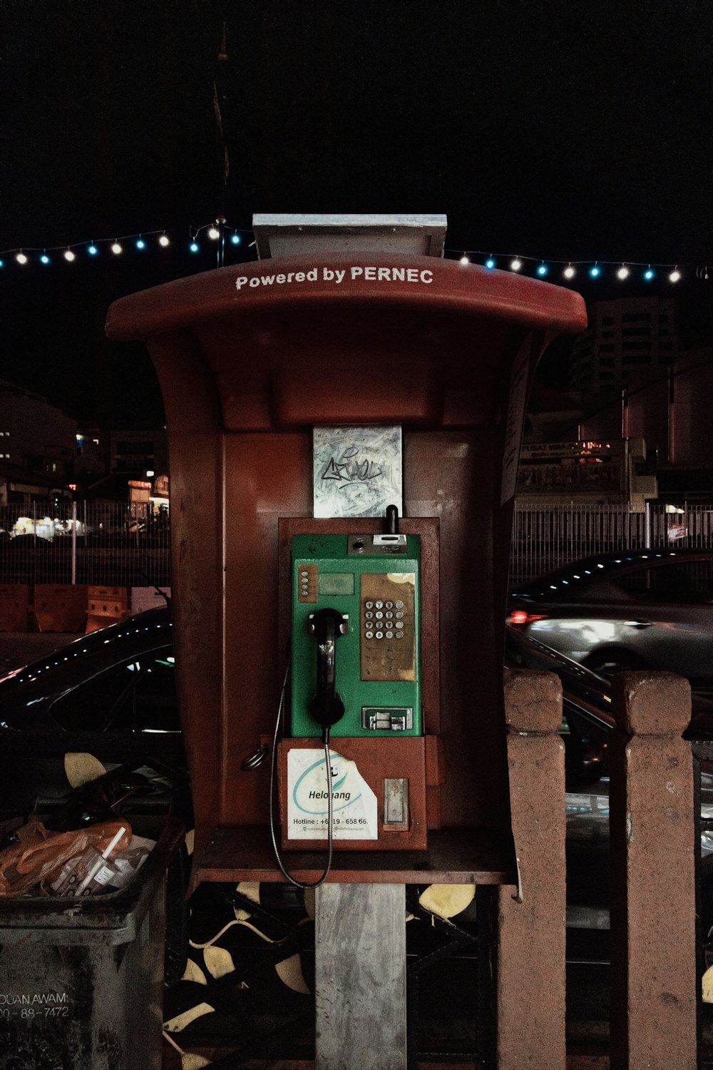 red telephone booth near road during night time