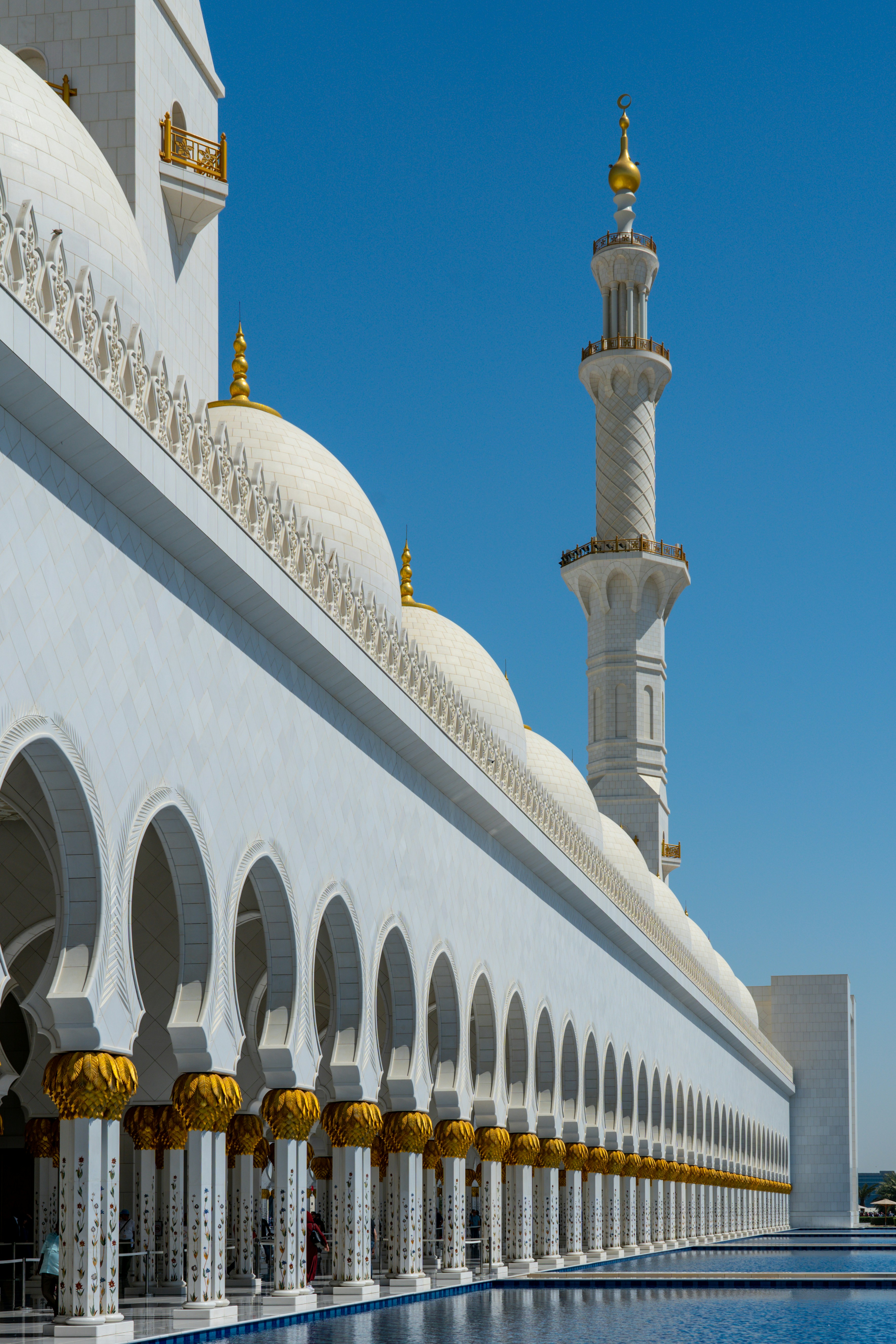 One of the exterior walkways at the Sheik Zayed Grand Mosque, Abu Dhabi. The white of the marble and blue of the water and sky, compliment each other perfectly.