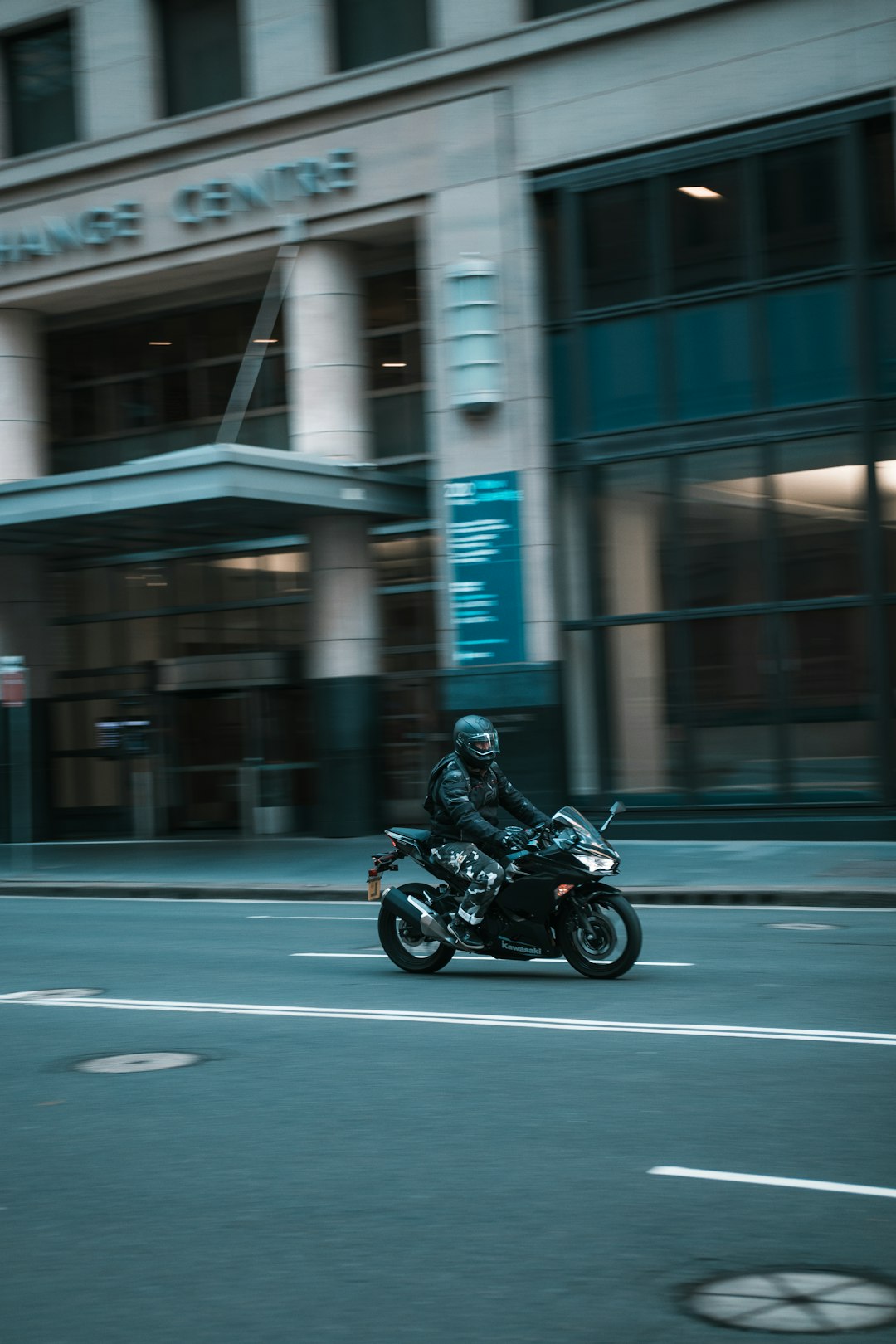 man in black jacket riding motorcycle on road during daytime