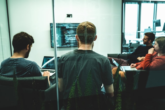 man in green crew neck shirt sitting on chair