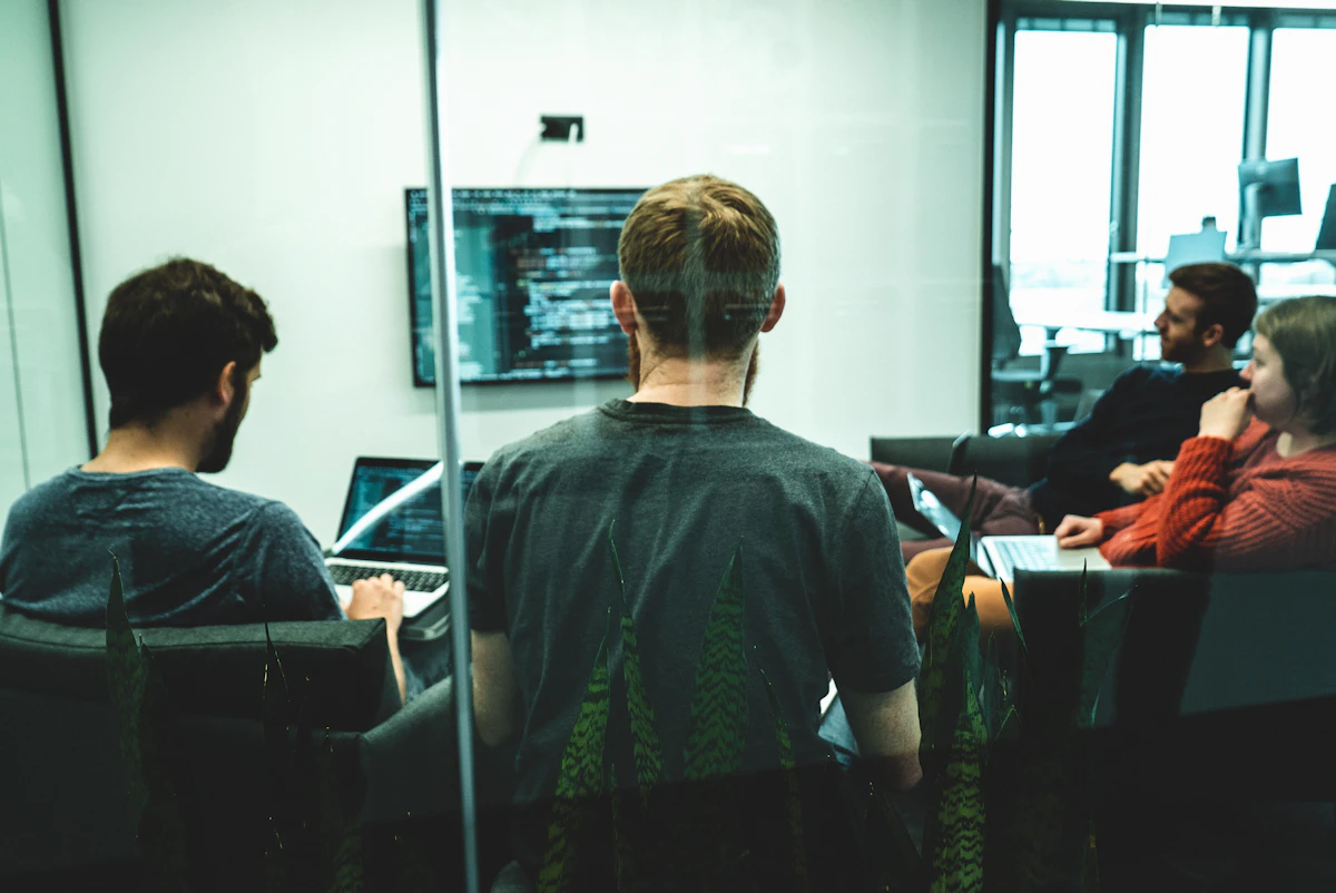 man in green crew neck shirt sitting on chair