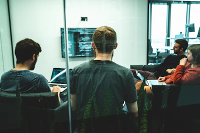 man in green crew neck shirt sitting on chair