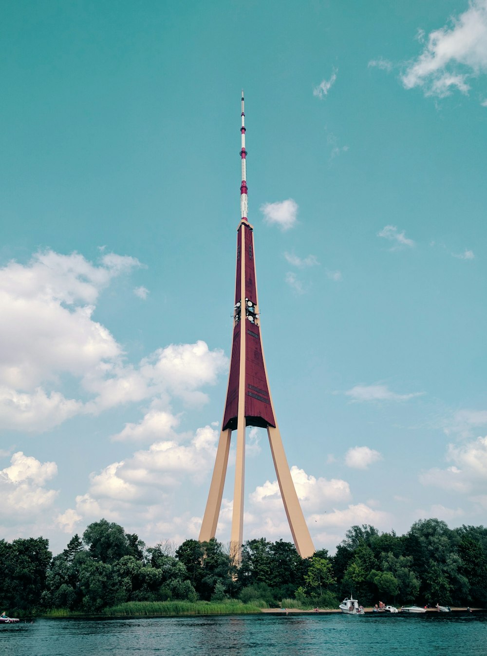 red and white metal tower under blue sky during daytime