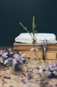 purple flowers in clear glass vase