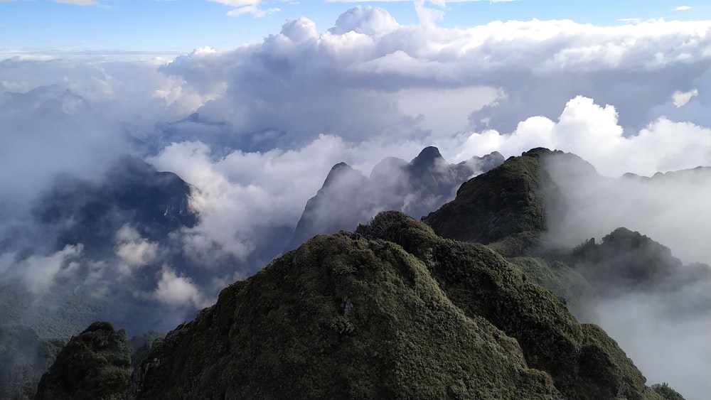 green mountain under white clouds during daytime