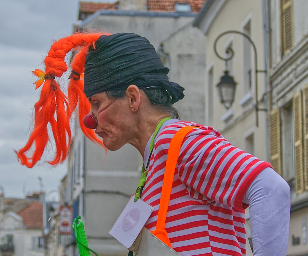 man in red white and black striped long sleeve shirt with orange powder on his face