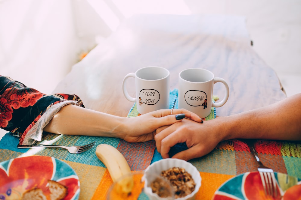 person holding white ceramic mug