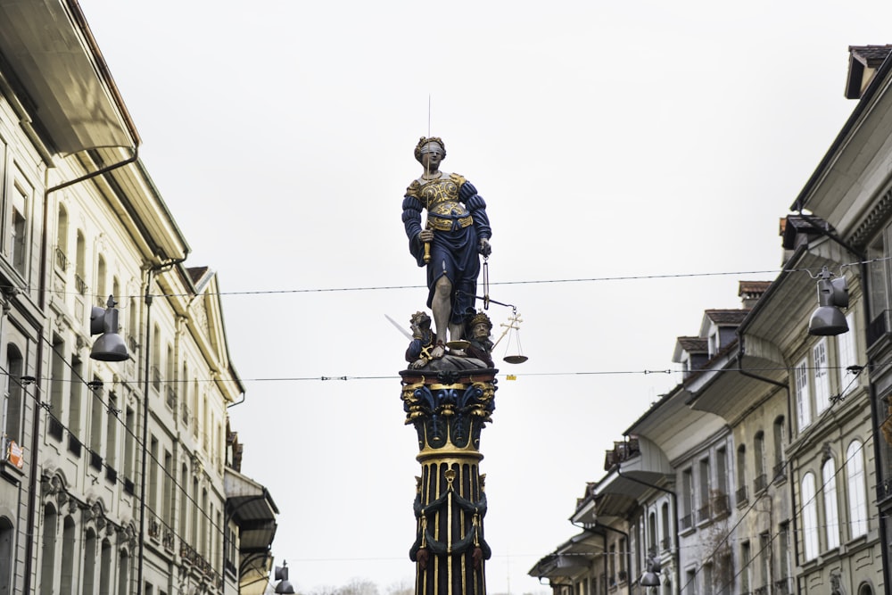 man in blue jacket statue