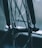 A close-up view of a bicycle wheel hub, showcasing intricate spokes and mechanical components. The focus is on the central hub with a logo, while the background is softly blurred, giving a sense of depth.