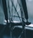A close-up view of a bicycle wheel hub, showcasing intricate spokes and mechanical components. The focus is on the central hub with a logo, while the background is softly blurred, giving a sense of depth.