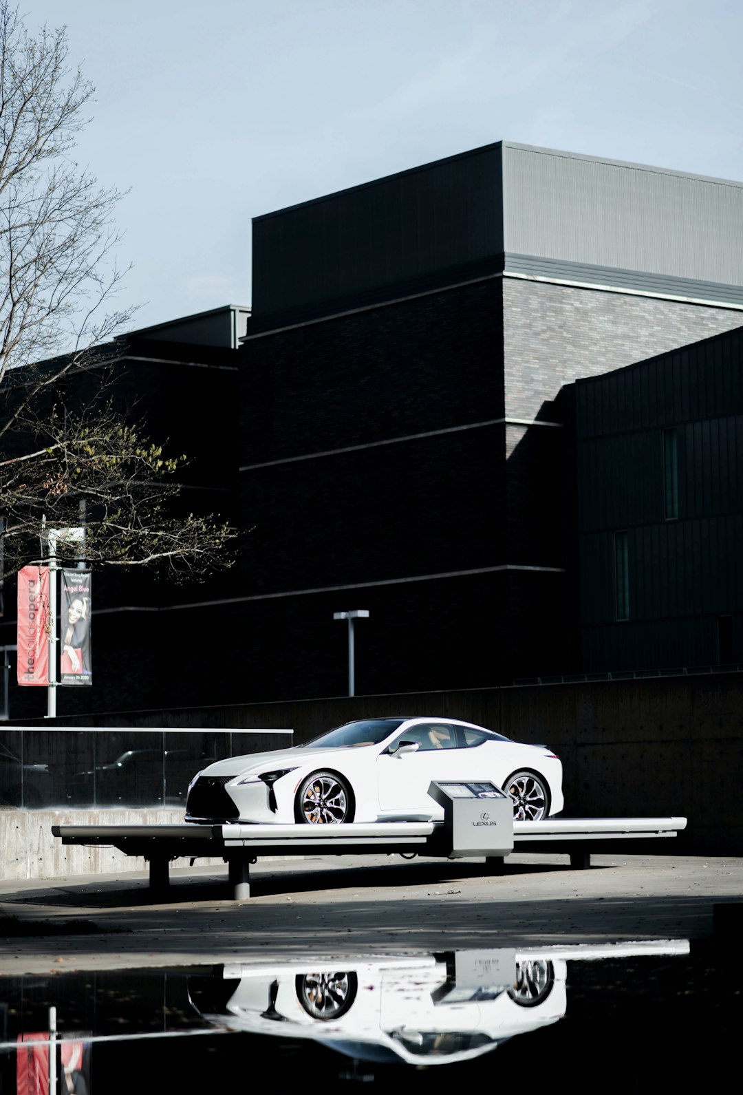 white coupe parked near building during daytime