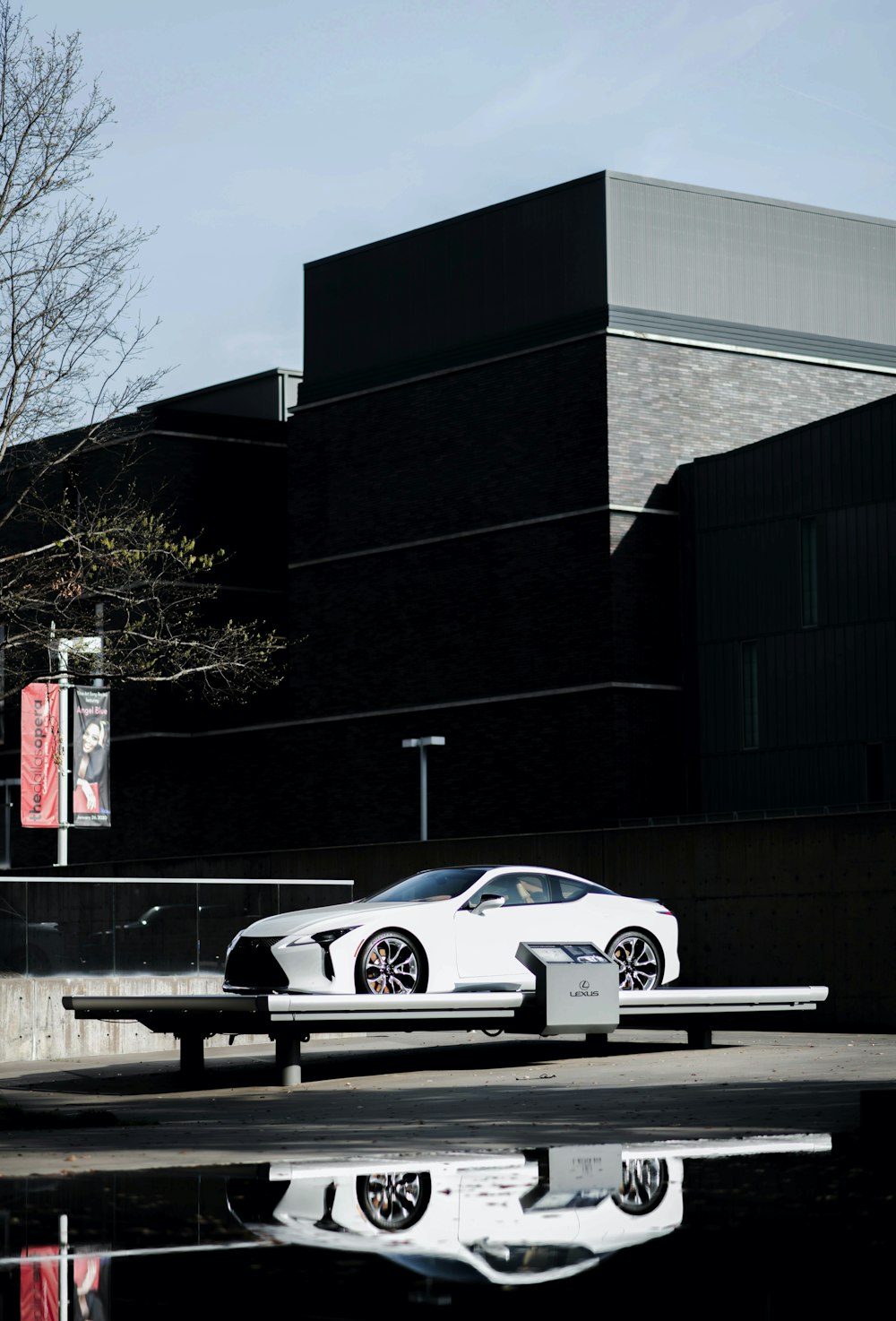 white coupe parked near building during daytime