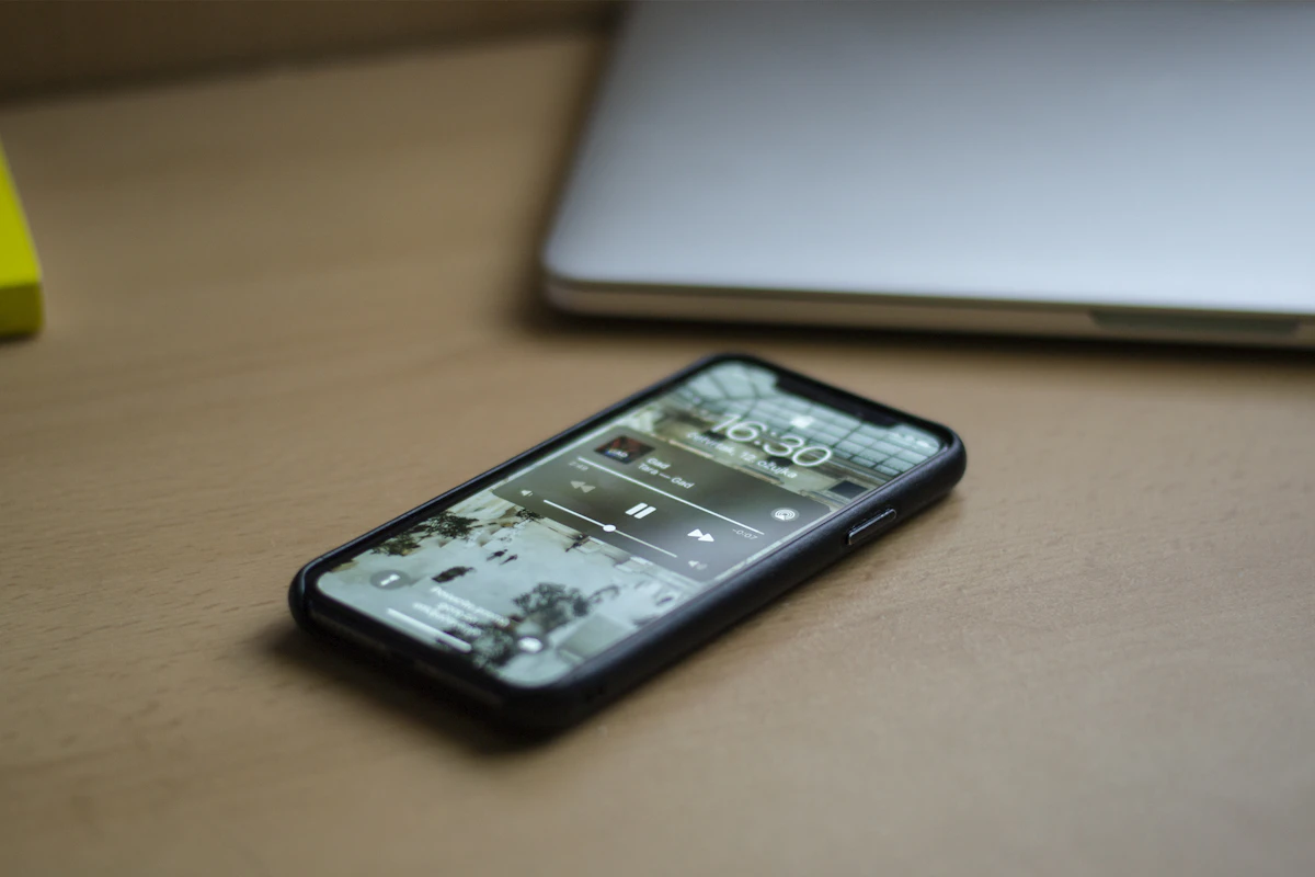 Black android smartphone on brown wooden table