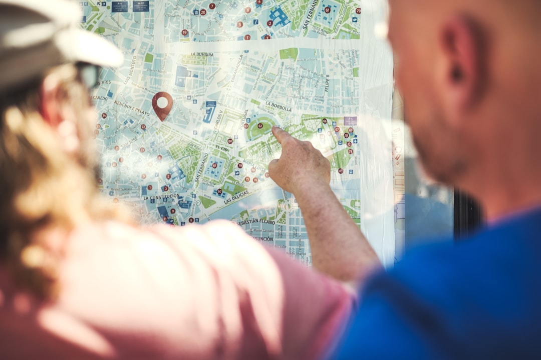 person holding green and white map