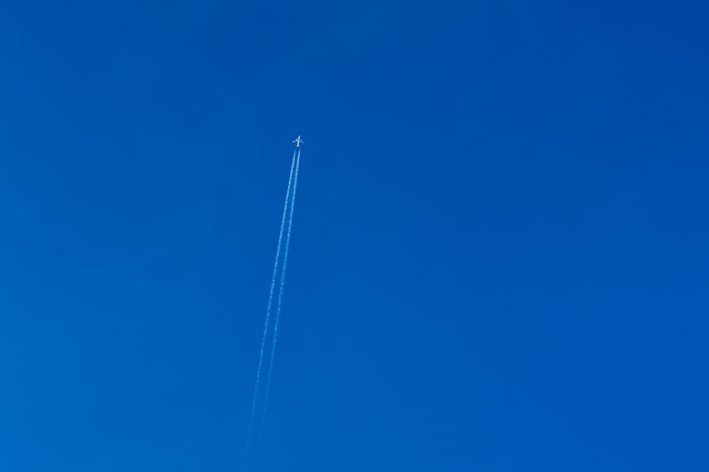 white electric post under blue sky during daytime