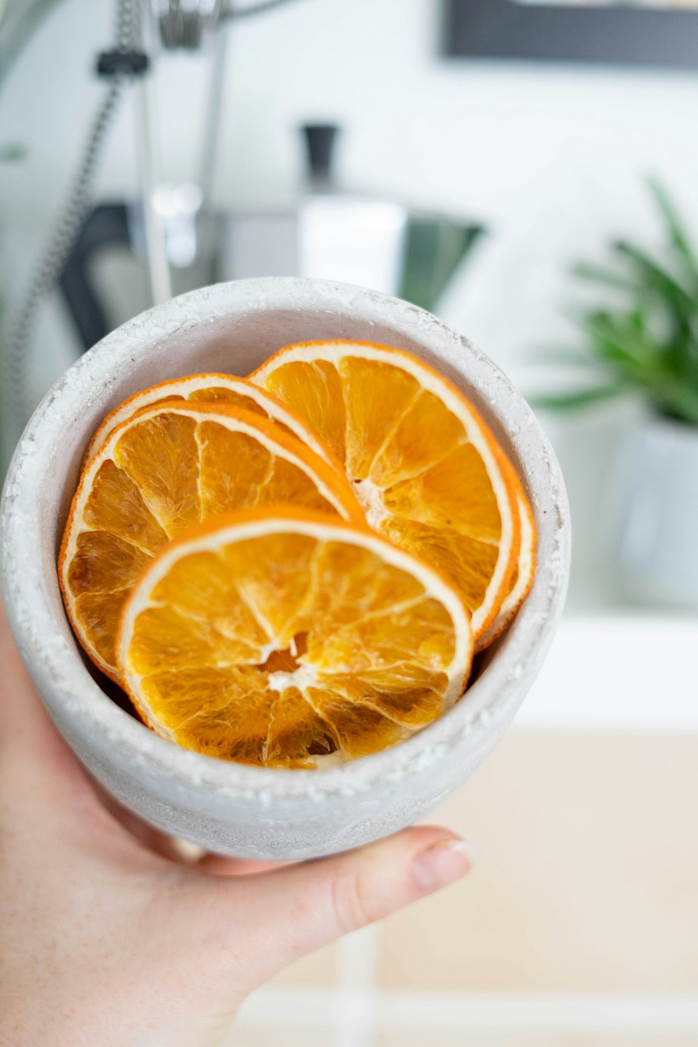 sliced orange fruit in white ceramic bowl