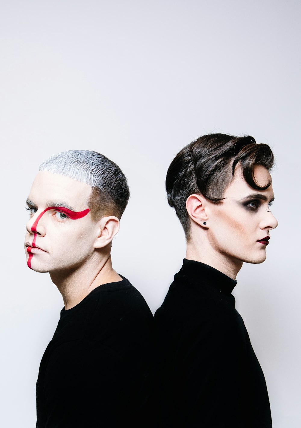 man in black crew neck shirt beside woman in red lipstick