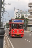 red and blue bus on road during daytime