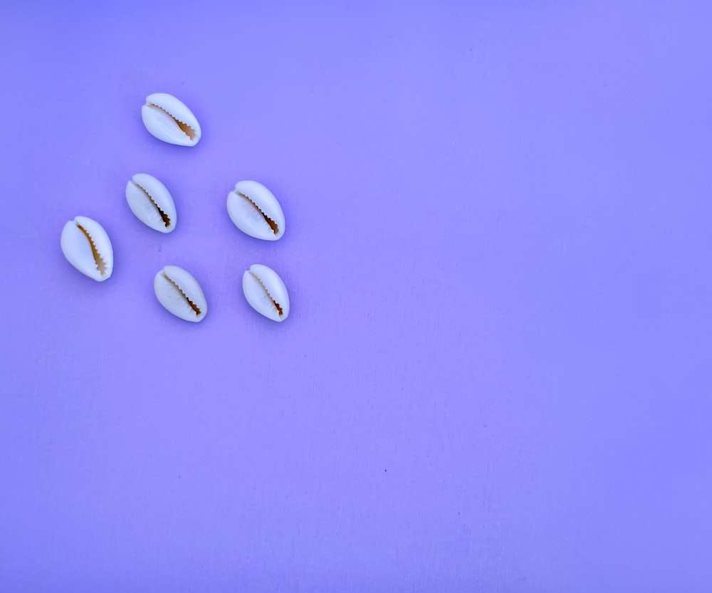 white medication pills on blue textile