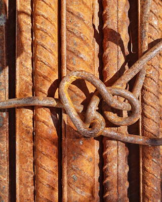 Fiberglass rods bundled together, showcasing their corrosion-resistant surface in an industrial setting.