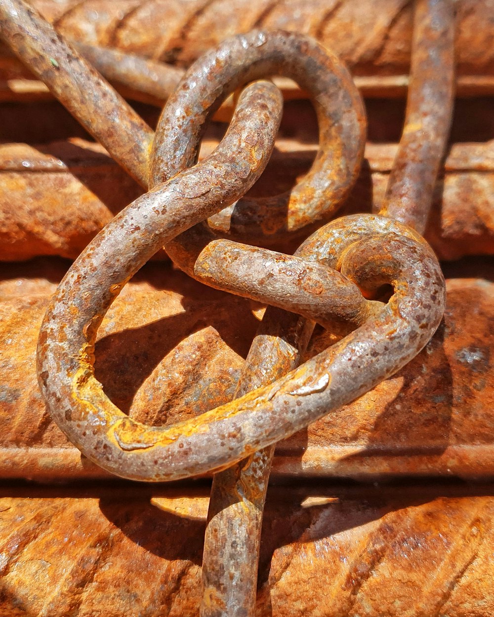brown metal chain on brown brick