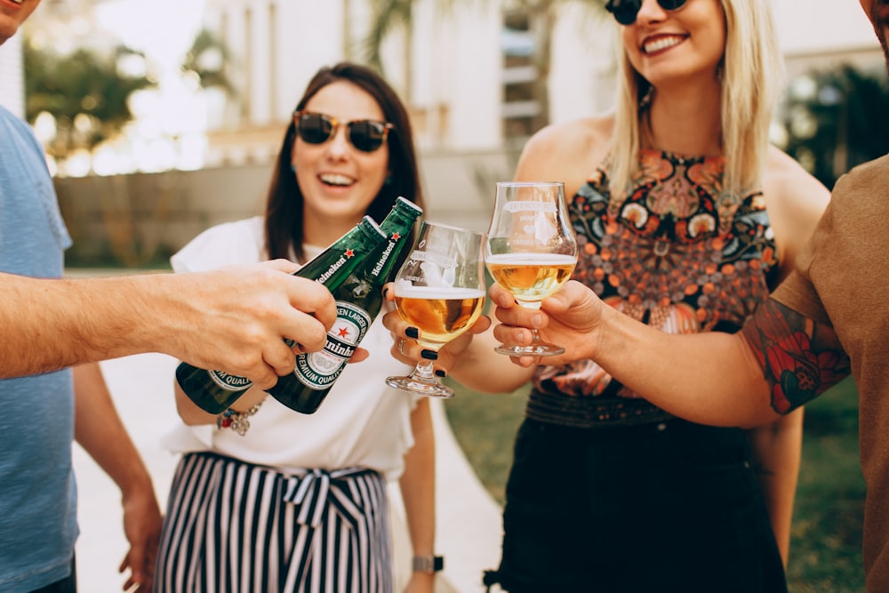 woman in black tank top holding wine glass