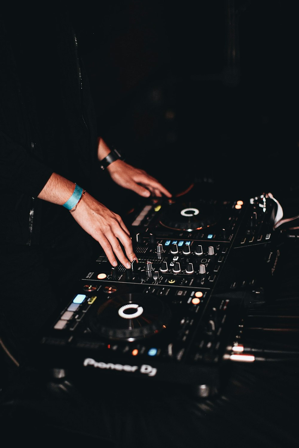 person in black long sleeve shirt playing dj controller