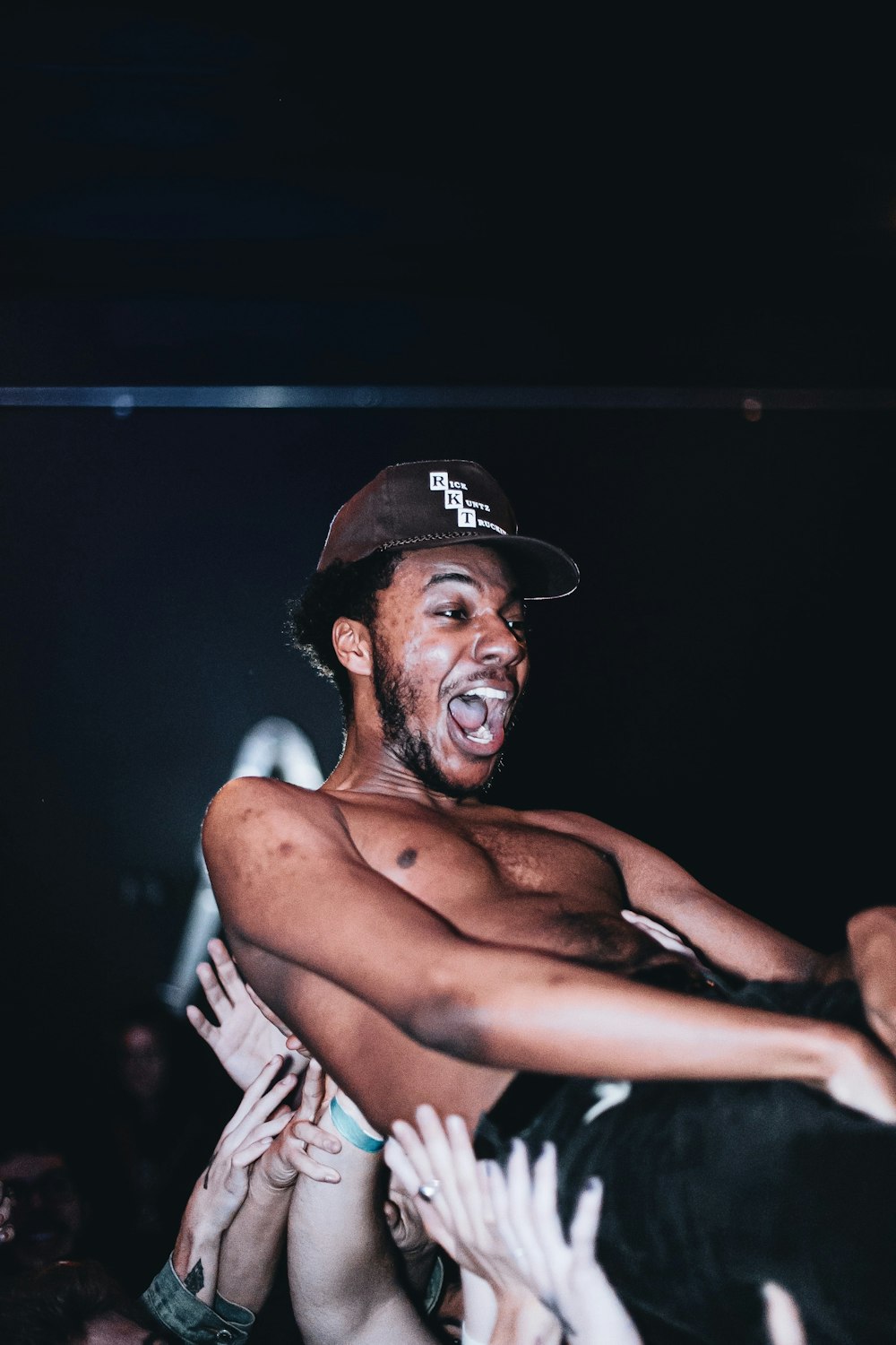 topless man wearing black fitted cap