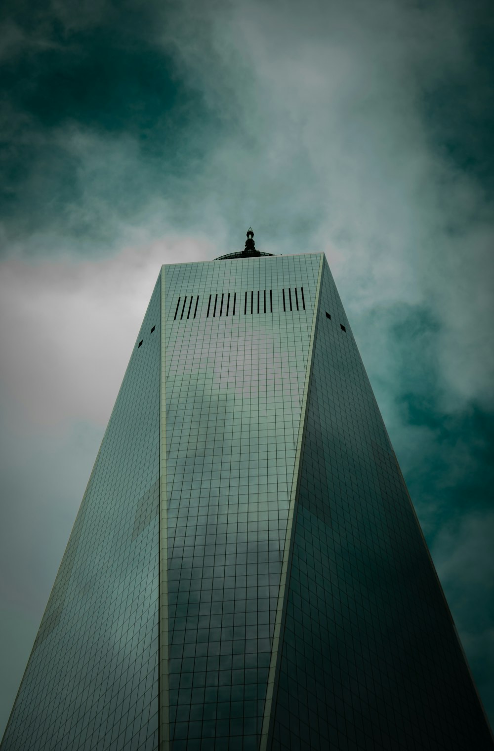 gray high rise building under gray clouds