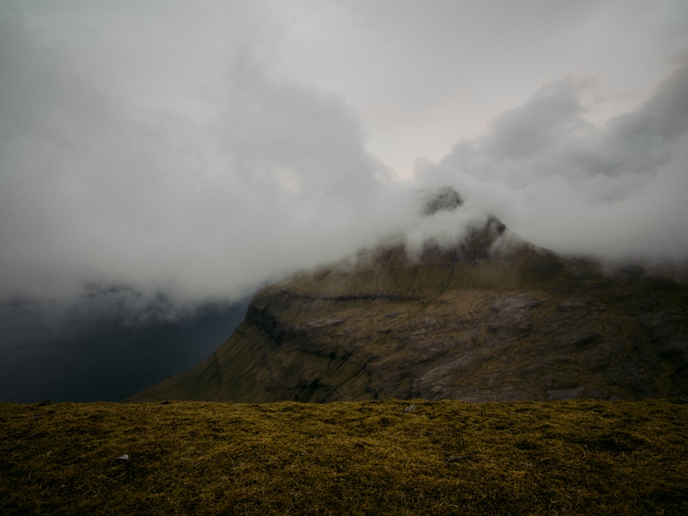 brown mountain under white clouds