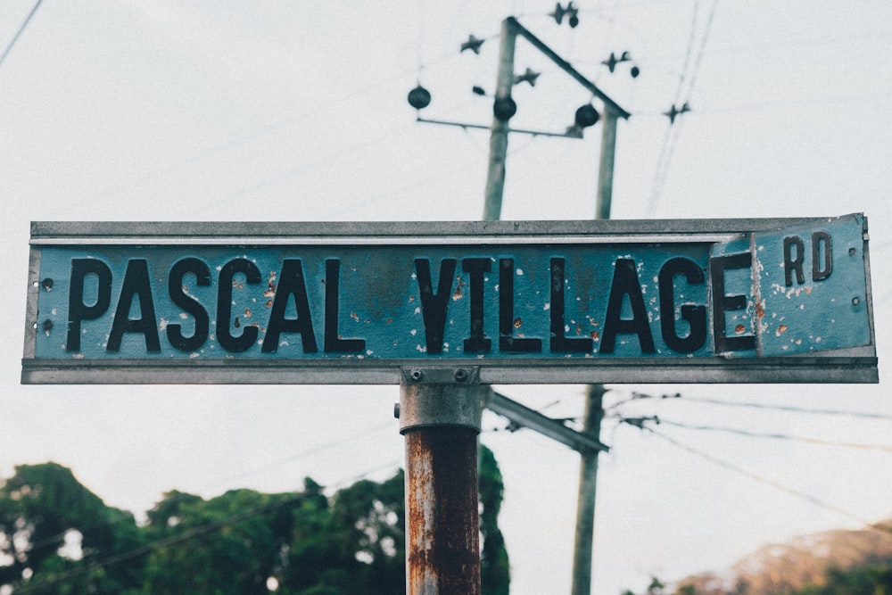 a street sign that reads pascal village rd