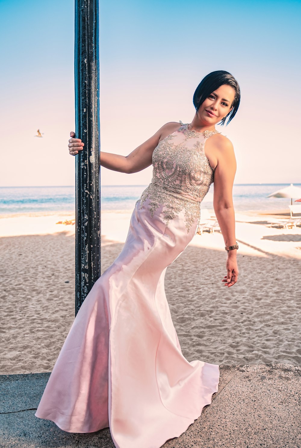 woman in white dress standing on beach during daytime