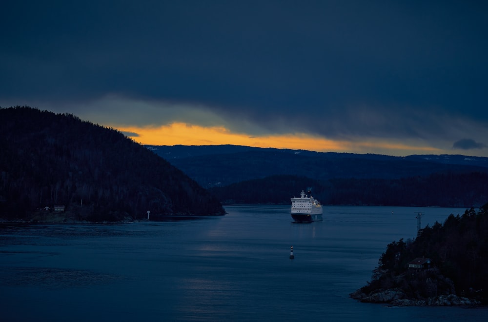 white ship on sea near mountain during daytime