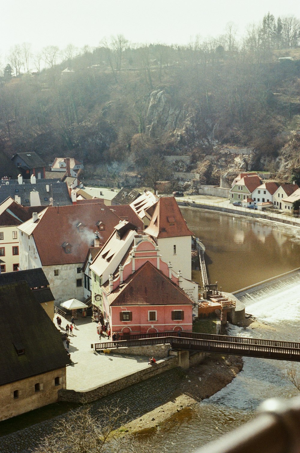 brown and white concrete houses near river during daytime