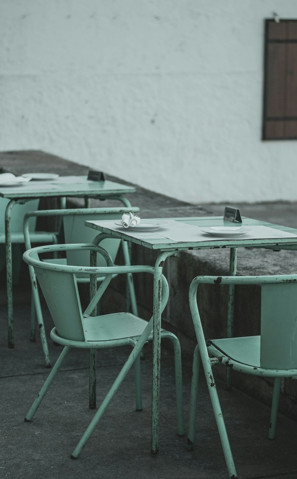 weißer Tisch mit grünen Stühlen